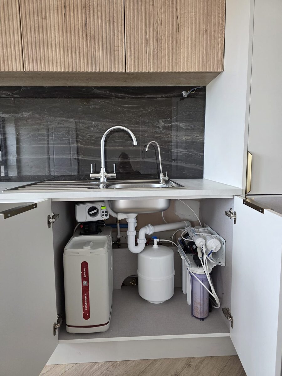 Softener and five stage reverse osmosis system with storage tank under a kitchen sink