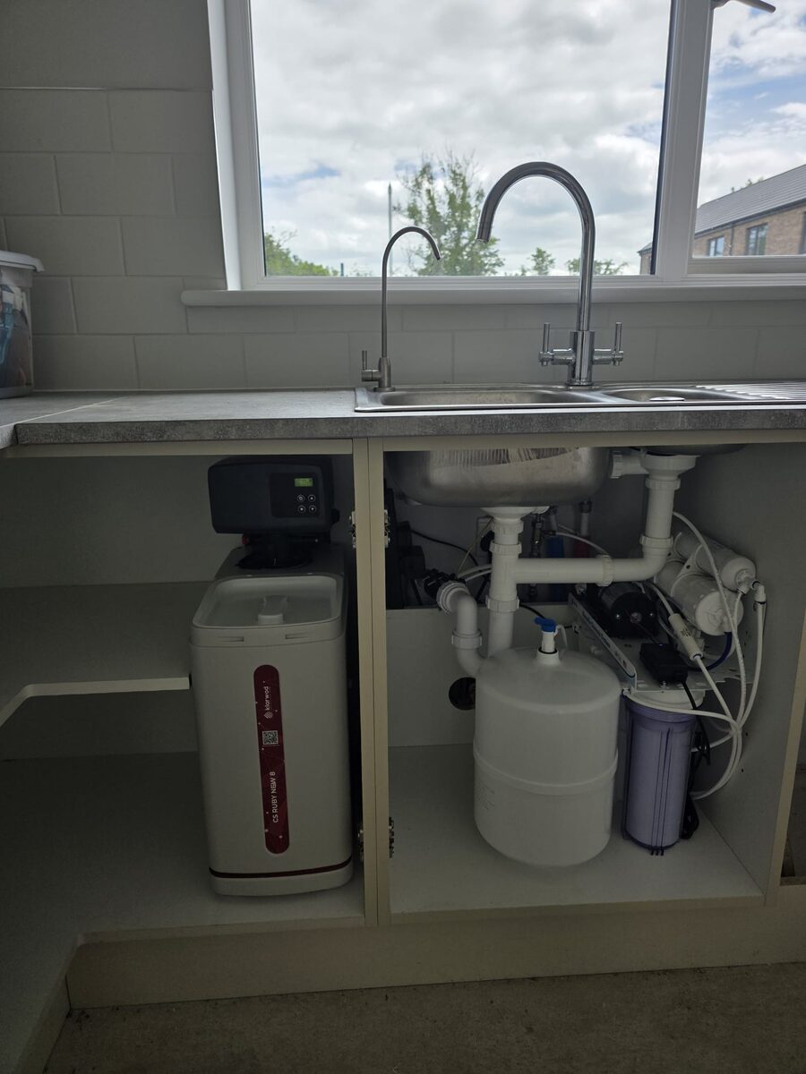 Reverse osmosis system with pressure tank and softener in a bright kitchen